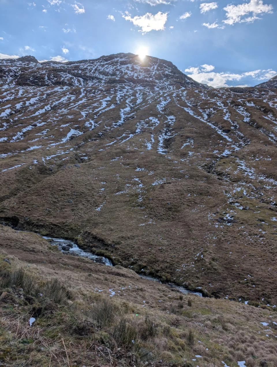 Steep slope with a burn and the first ribbons of snow