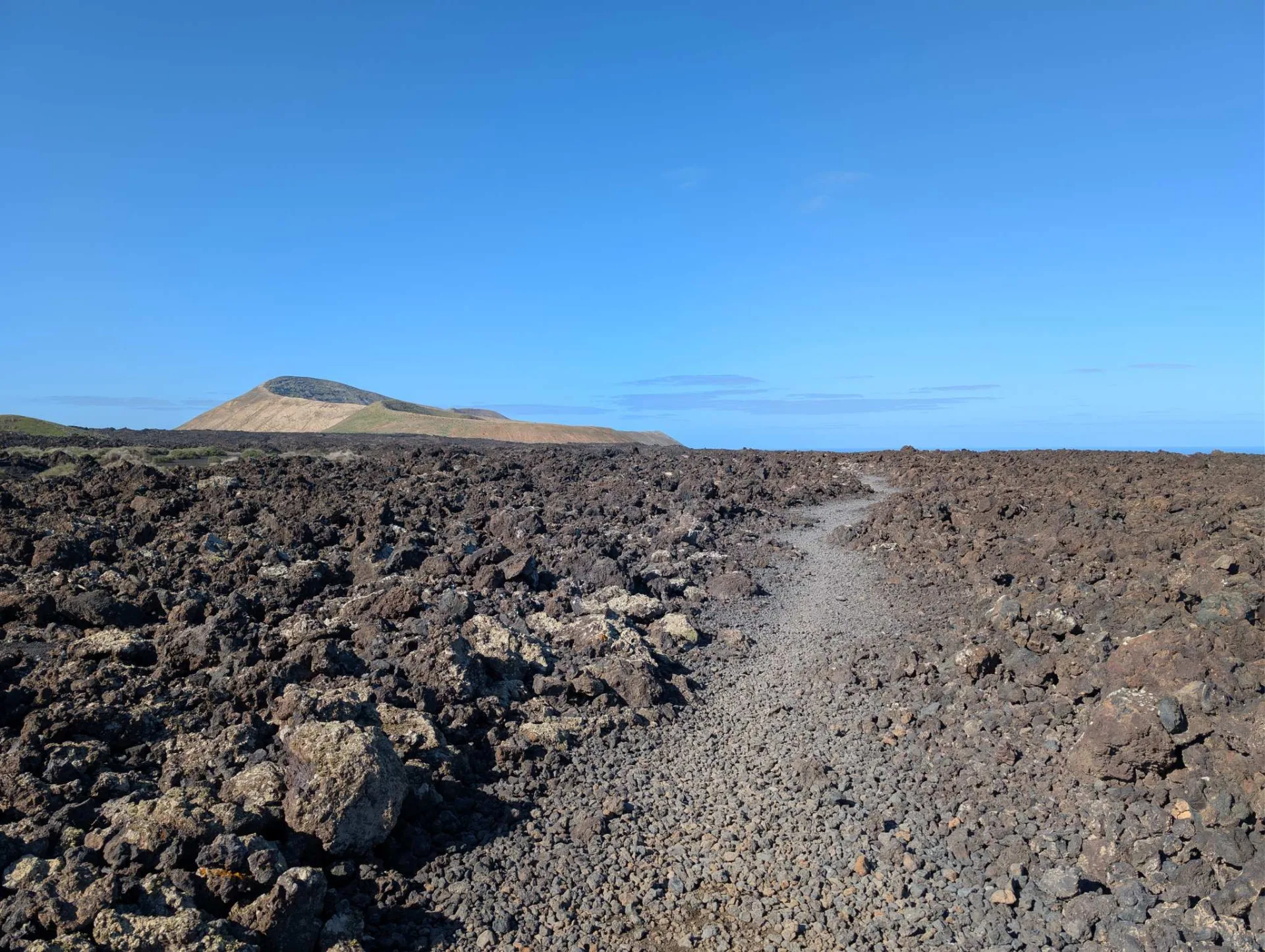 A stony path winds back through the frozen lava.