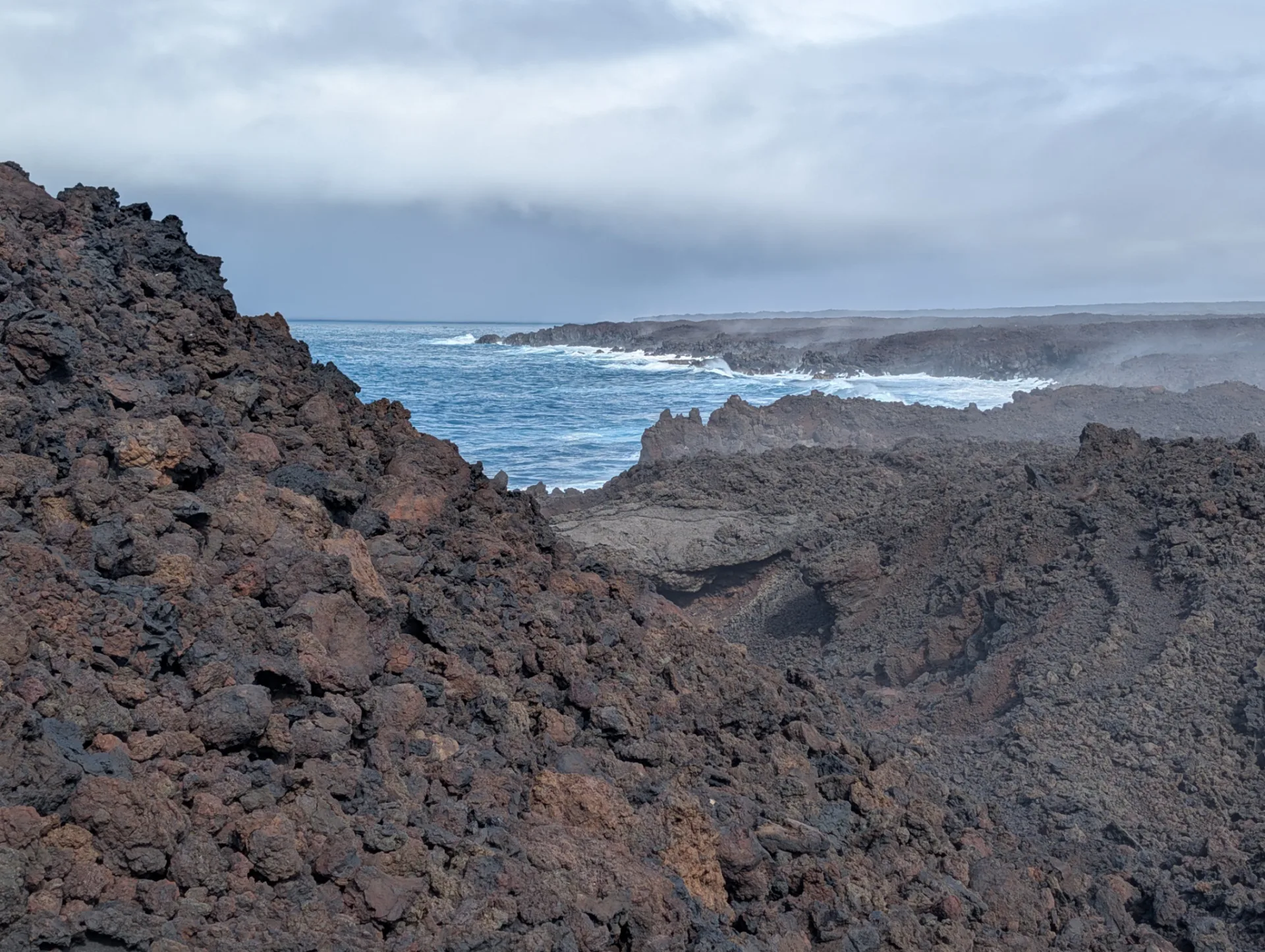 Rugged lava cliffs and surf on the long way north.