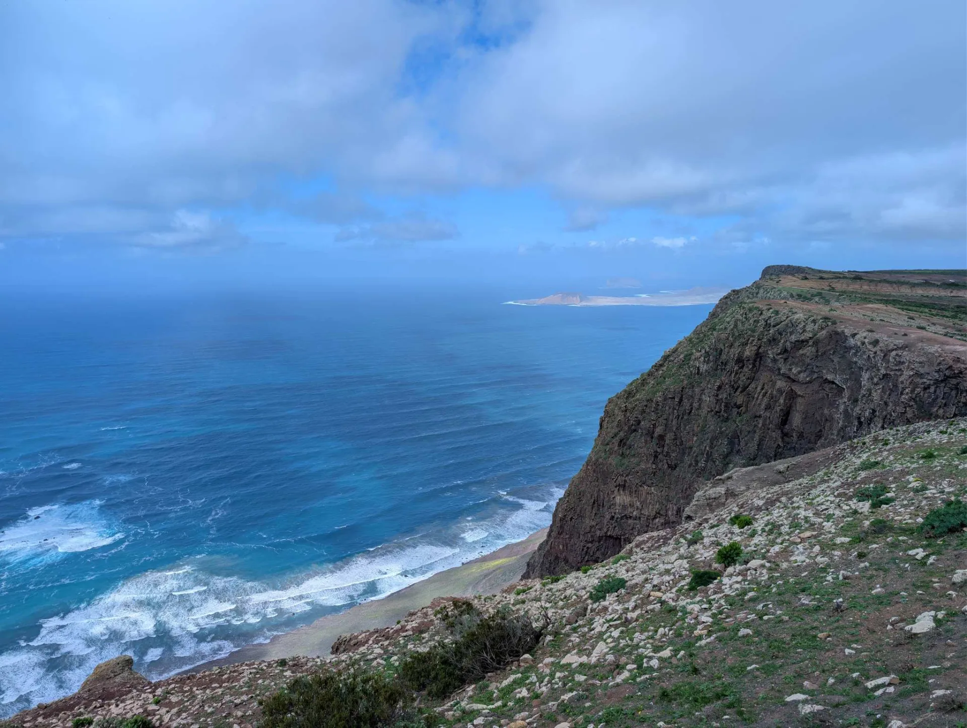 High above the sea: the Risco de Famara drops steeply to the turquoise water, La Graciosa on the horizon.
