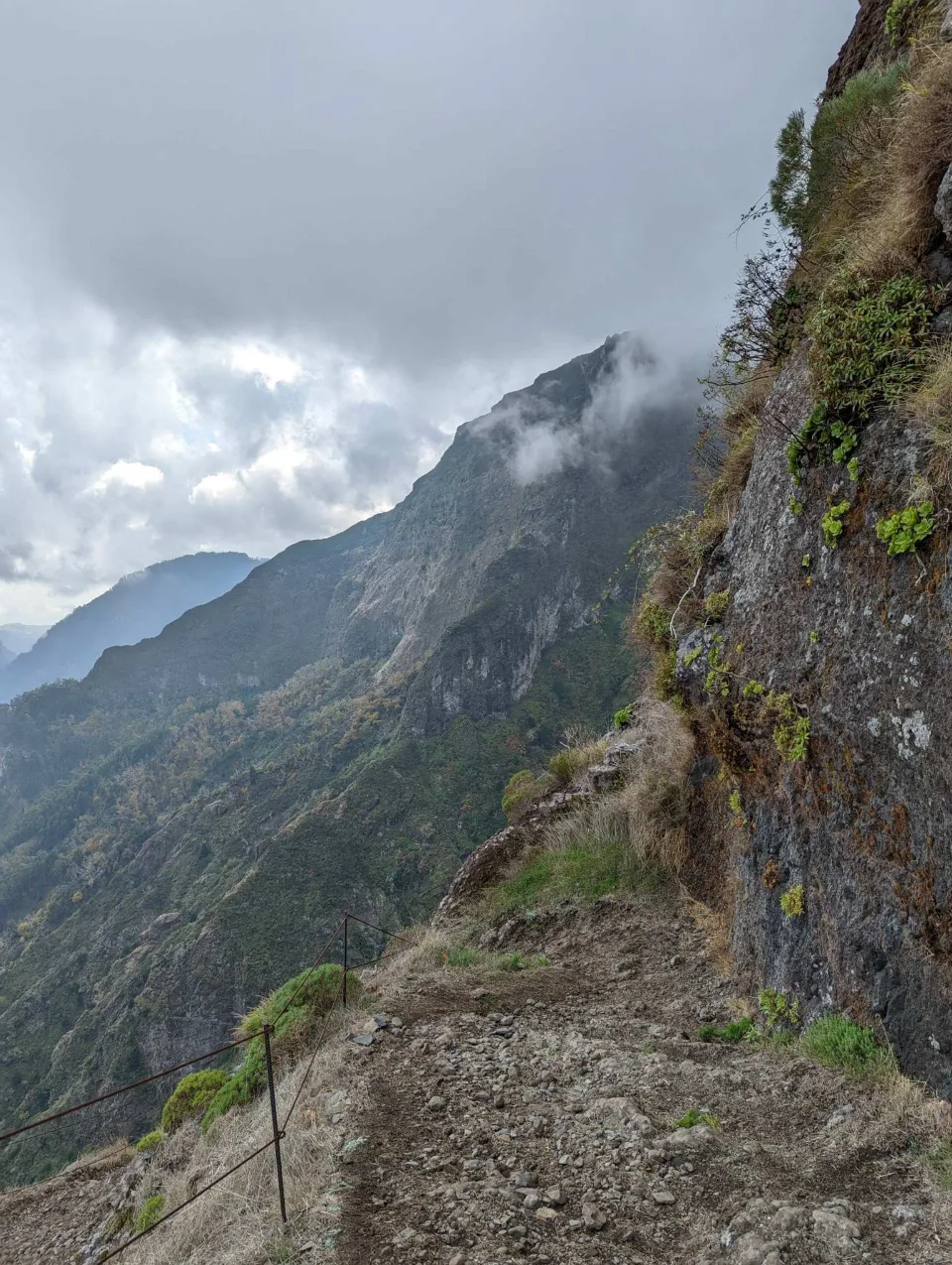 A narrow path on the cliff face as clouds gather