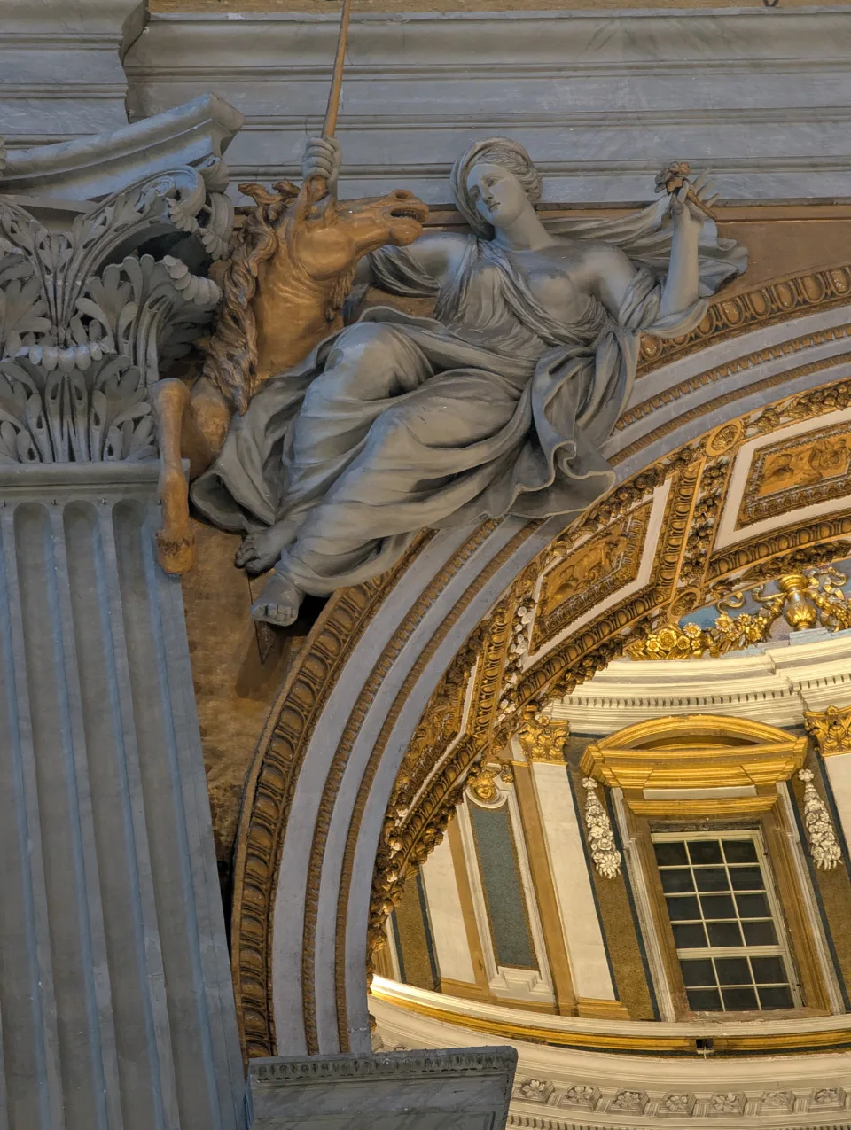 Marble sculpture at a pier inside St. Peter's, dome above