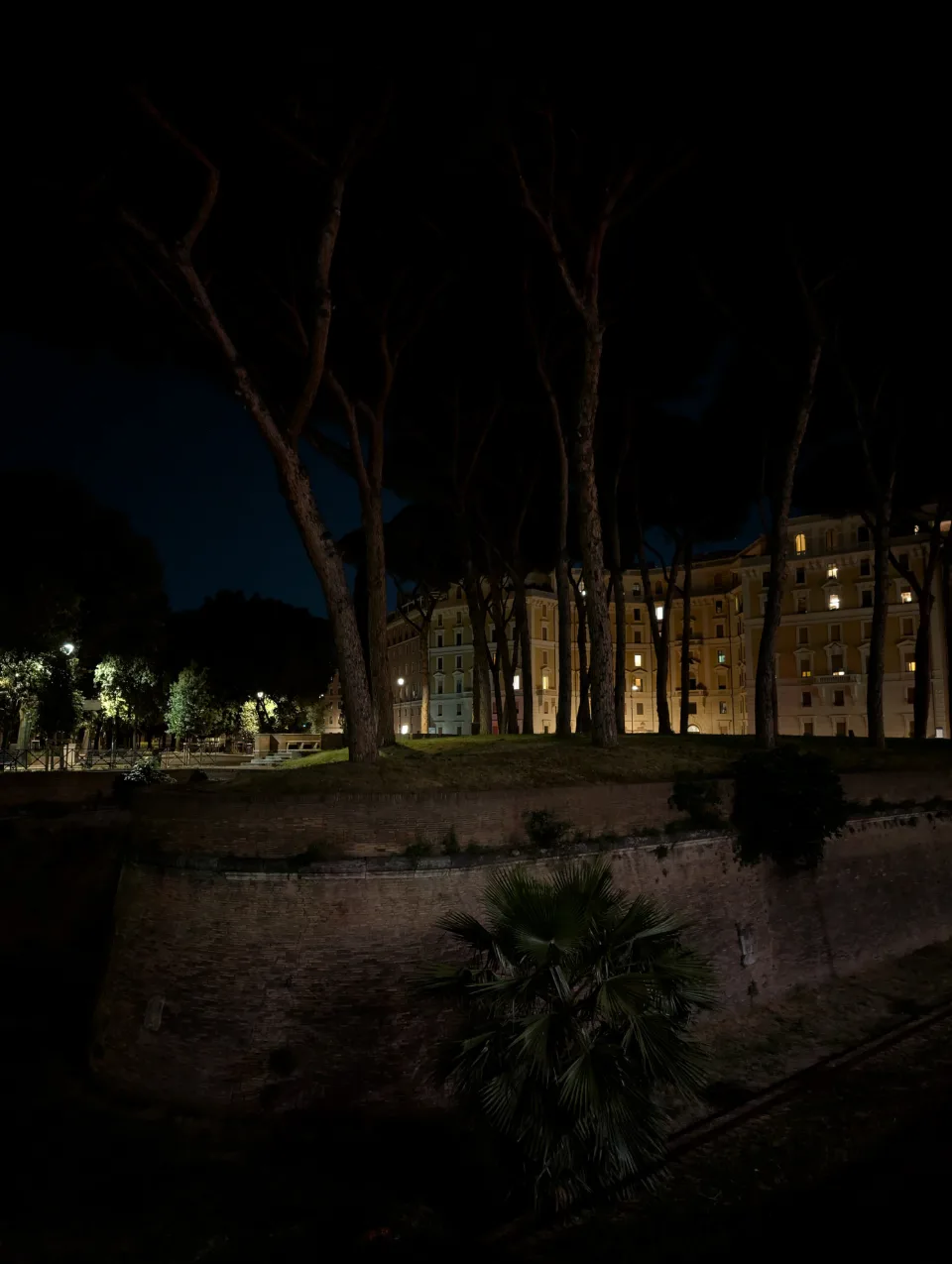 Stone pines and palazzo in the park near Castel Sant'Angelo, evening