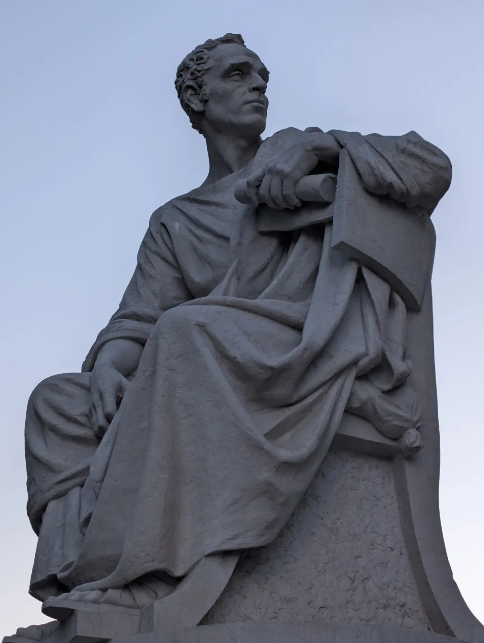 Marble sculpture of a scholar at dusk