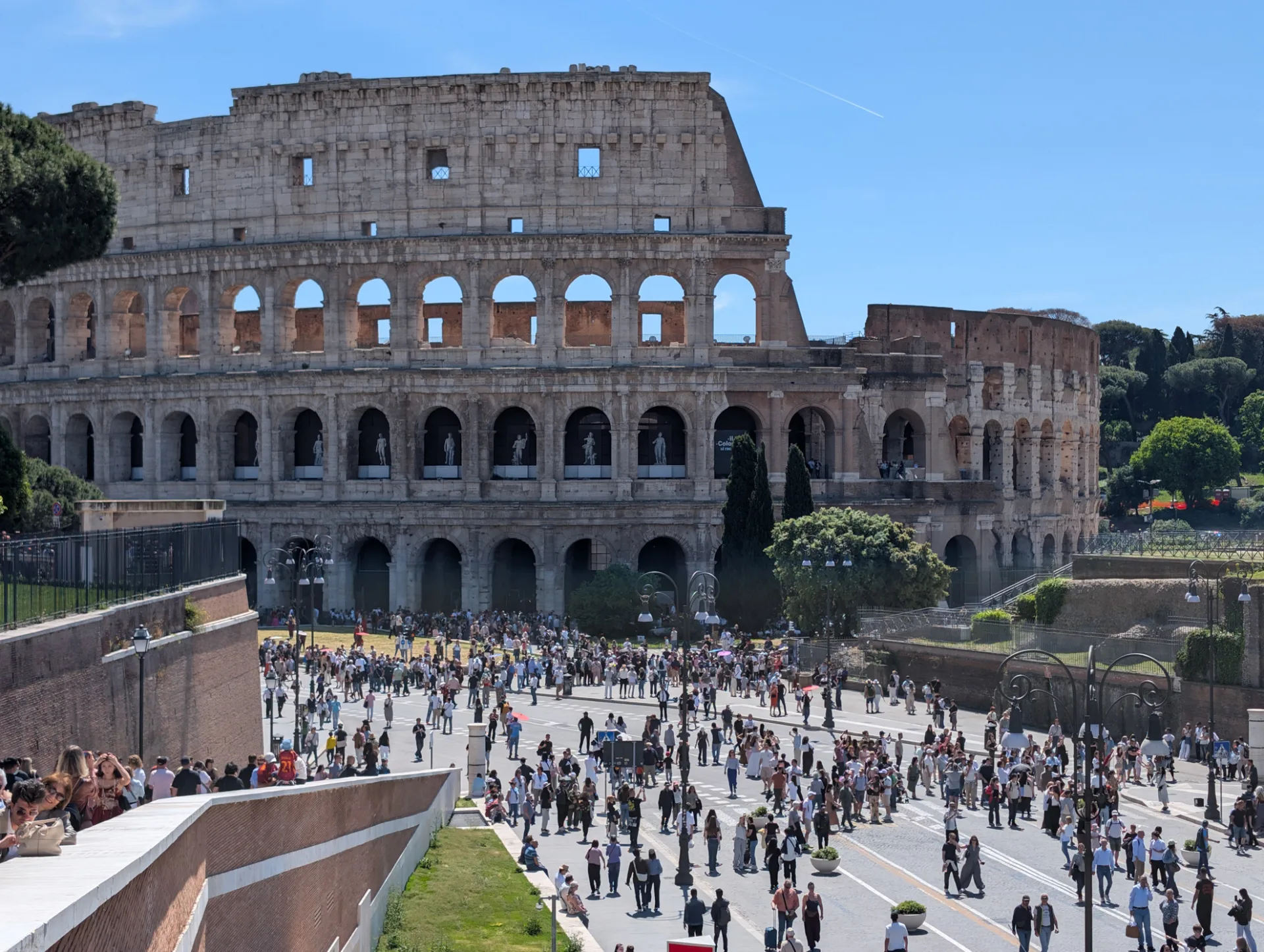 The Colosseum from above — the tourist crowds tiny in the foreground