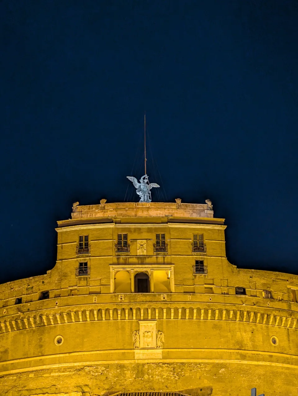 Castel Sant'Angelo at night, bathed in golden light