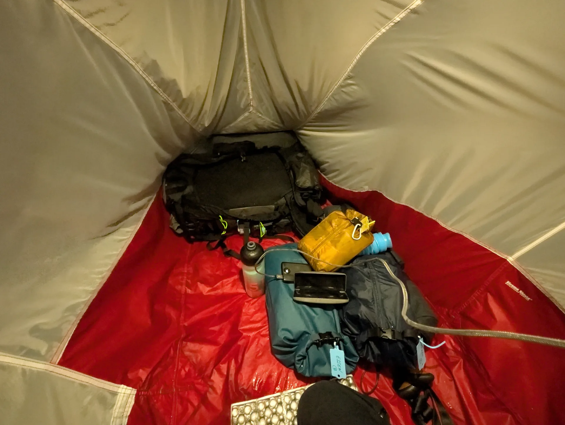 Inside the tent with pack, water bottle and kit — almost everything dry