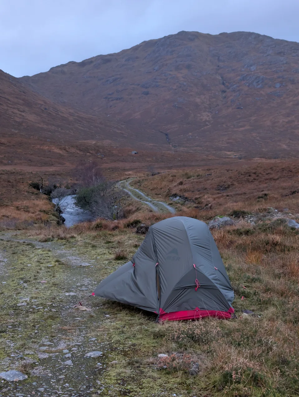 Tent in the morning, day 2 starts grey — path and burn right alongside
