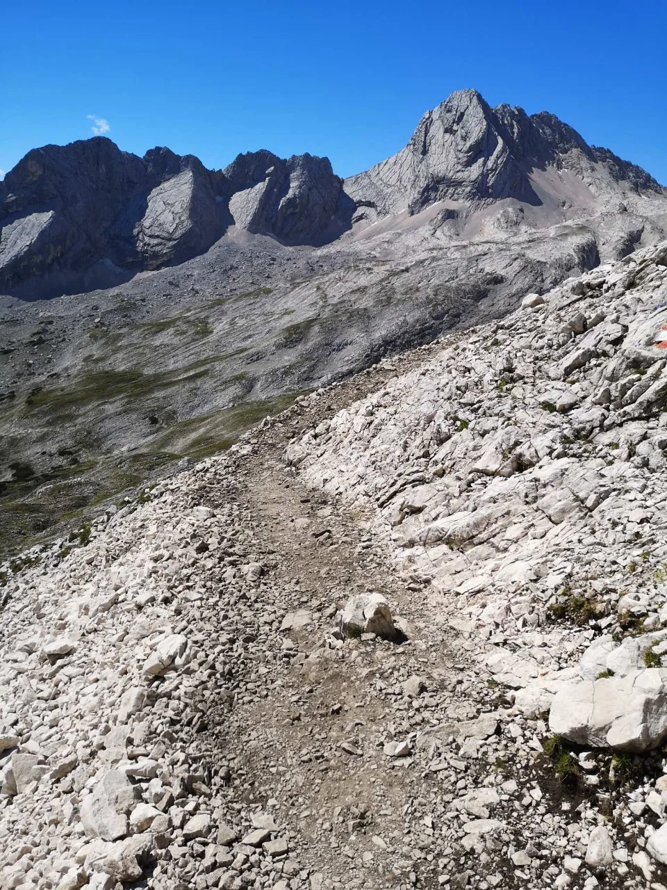 Over scree and rubble the path climbs into the high cirque.